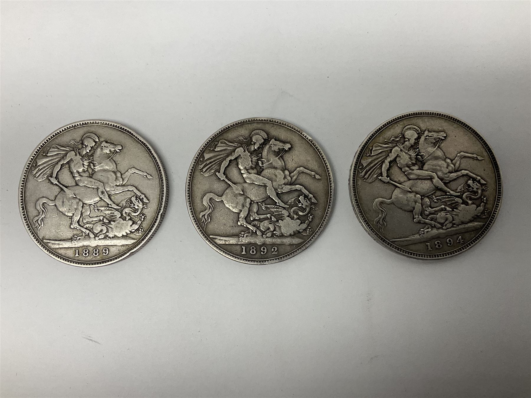 Three Queen Victoria silver crown coins dated 1889, 1892 and 1894