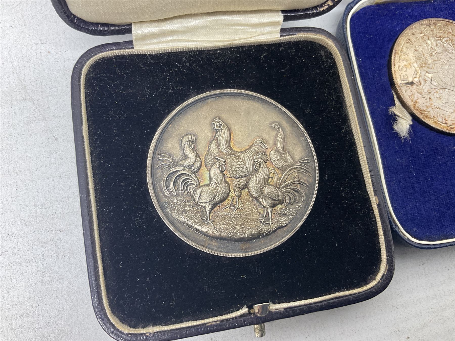 Commemorative coins and medallions, including hallmarked silver poultry medal, Royal Mint 'College of Arms Quincentenary Commemorative Medal', Selby Abbey '1069 1969' medallion, two medallions commemorating the Investiture of H.R.H. Prince Charles 1st July 1969 and a set of four coins commemorating the Investiture of Prince Charles, all cased 