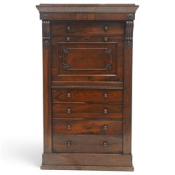 Victorian rosewood Wellington secretaire chest, the projecting stepped cornice over a banded frieze with moulded rosette mounts, single drawer over a secretaire fall-front opening to reveal a maple lined interior with assorted pigeonholes and correspondence drawers, over a lappet carved lower edge with four graduating drawers below, each with turned pull handles, flanked by hinged lock to the right and plain stile to the left surmounted by reeded corbels, raised on a skirted base