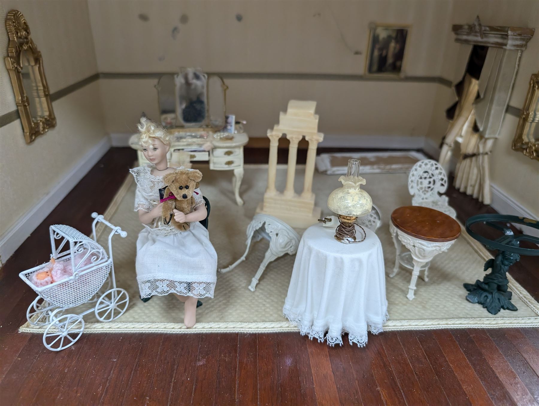 Two modern three storey dolls houses, each painted green with decorated interiors, both upon a single white wooden base, together with a large collection of dolls house furniture, accessories and figures 