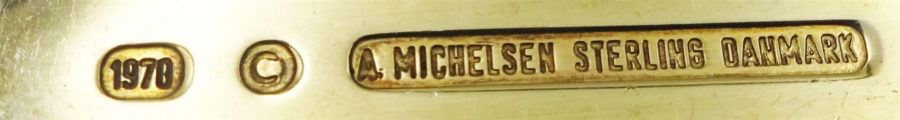 Collection of Danish silver and silver-gilt year spoons by Anton Michelsen, two examples with pierced enamel tree and berry decoration, dated 1932 and 1938, each impressed on underside A.Michelsen Copenhagen, Sterling Denmark, and a further five examples decorated with enamel floral and family designs, dated between 1970 and 1977, each impressed on underside A.Michelsen Sterling Danmark, impressed with varying artist signatures,  approximate gross weight 10.43 ozt (324.3 grams)