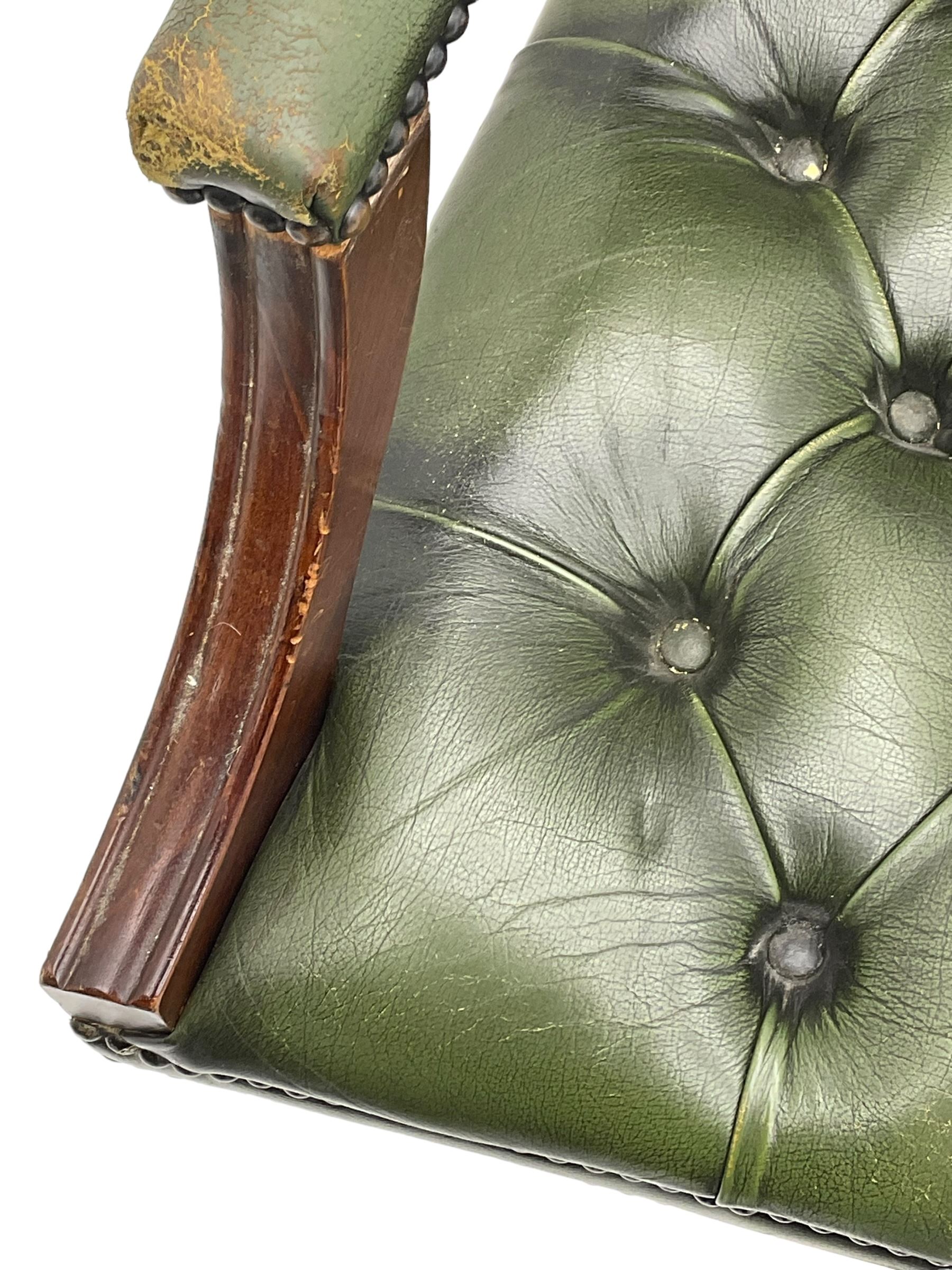 Georgian design swivel office desk chair, upholstered in buttoned green leather, on five spoke base with castors 