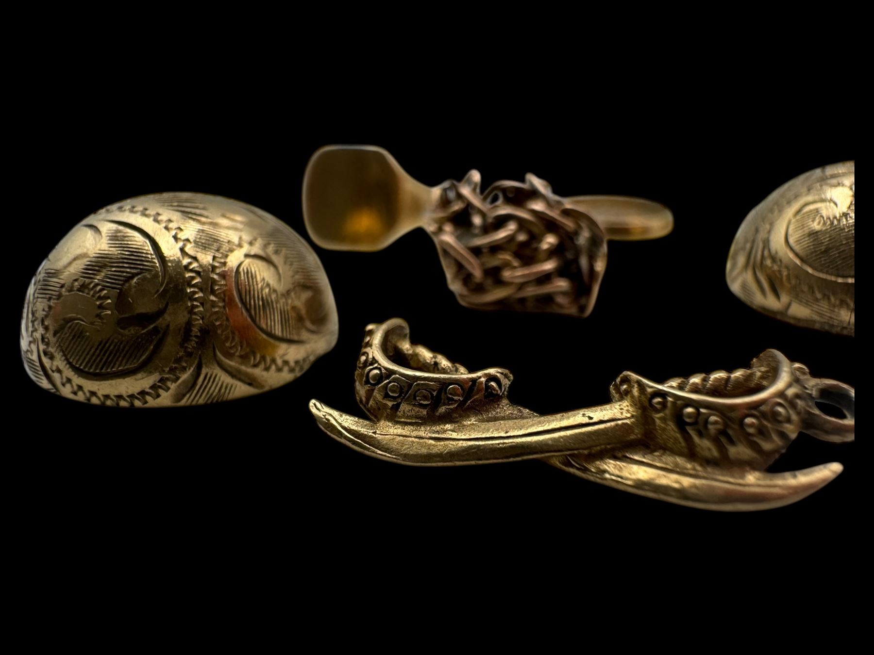 9ct gold charms, including crossed swords, signet ring, horseshoe and leaf, and a 14ct gold fireplace charm