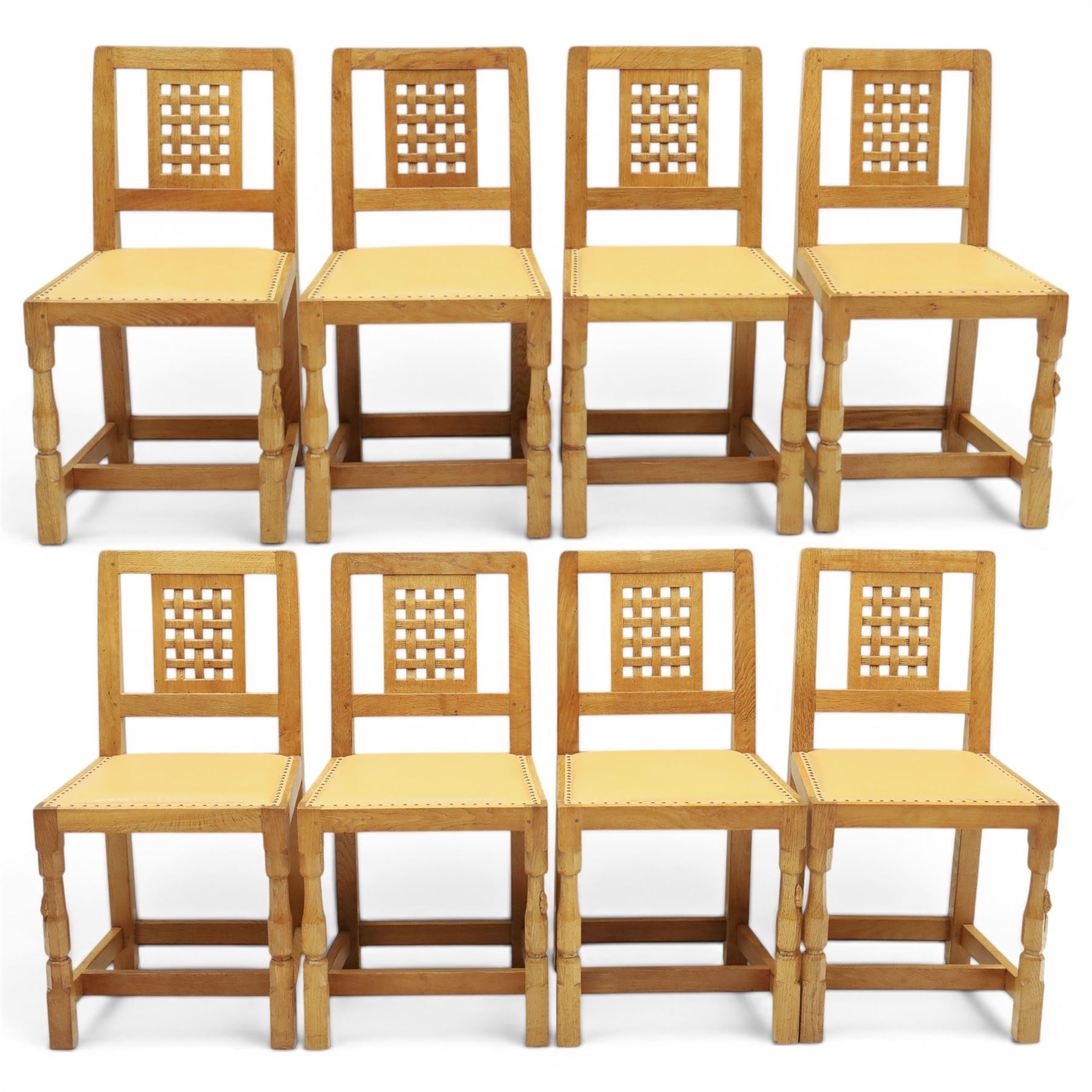 Mouseman - set of eight light oak dining chairs, each with lattice panel back and tan leather upholstered seat, raised on octagonal front legs joined by stretchers, with signature carved mouse, by the workshop of Robert Thompson, Kilburn