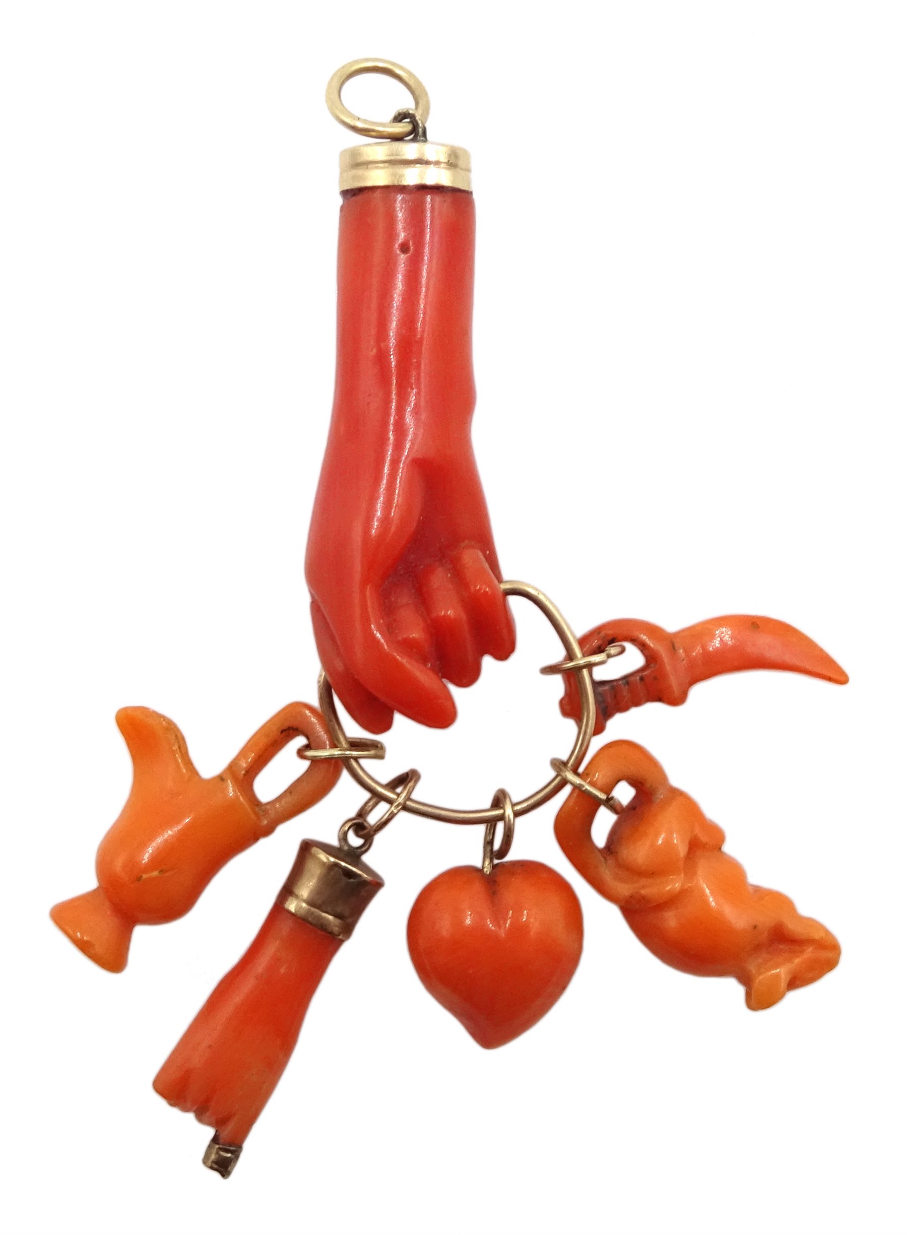 Victorian gold carved coral hand charm holding a heart, hand, jug, sword and mouse