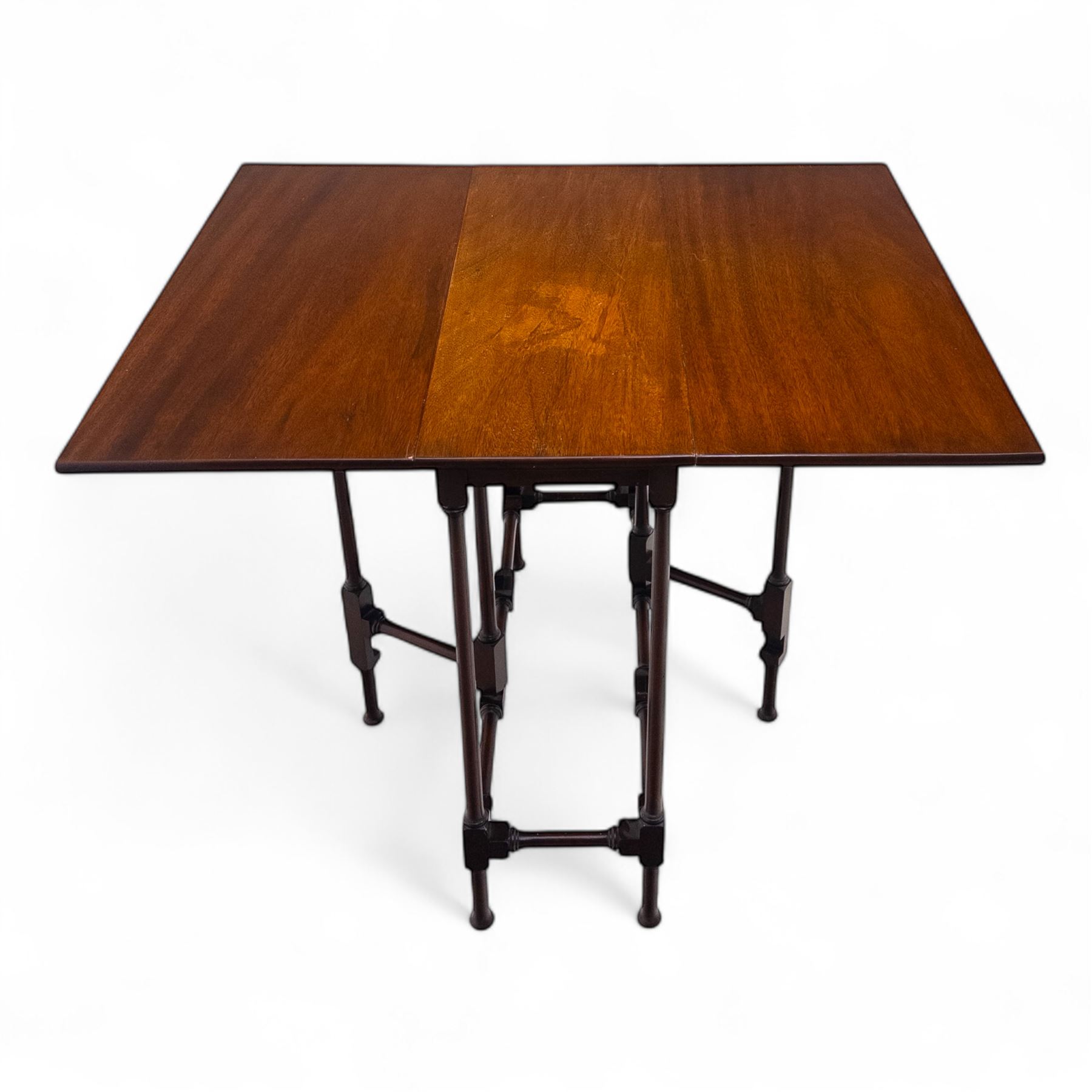 Set of two early 20th century mahogany occasional tables, comprising an oval example with under-tier and galleried shelf on swept supports, and a drop-leaf Sutherland table with turned gateleg supports and stretcher base (Oval H 74cm, W 57cm, D 86cm) (Sutherland H 71cm, W 30cm-94cm, D 76cm)