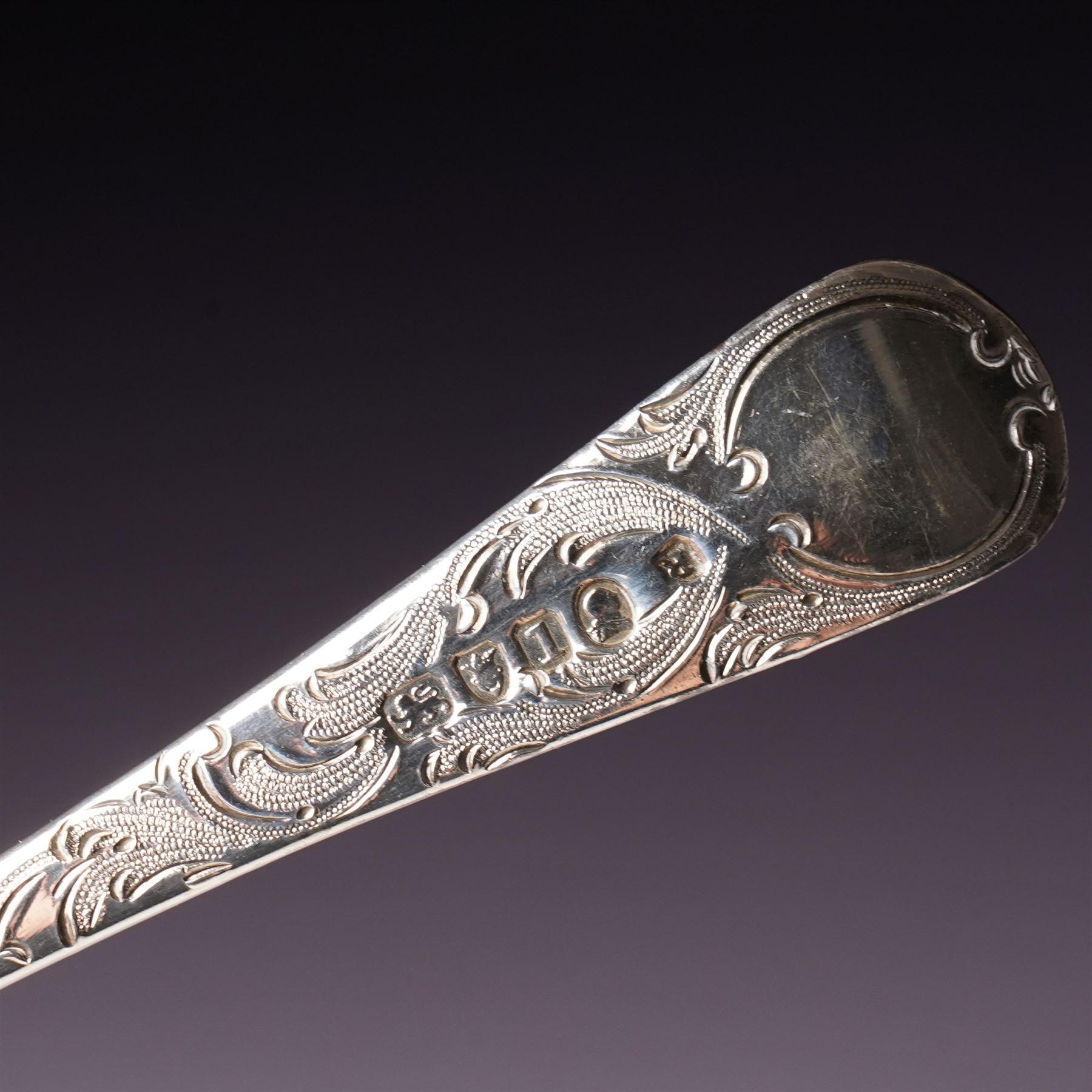 George III silver 'berry' spoon with later embossed and gilded bowl and engraved stem London 1786, sifting spoon similarly gilded and decorated and a George III silver fiddle and thread pattern table spoon London 1810 (3)
