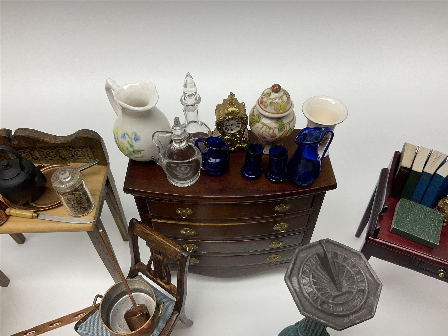 Collection of miniature dolls house furniture and accessories, to include long case clock, chest of drawers, tiled wash stand, ceramics and glass ware, mirror, baskets, etc 