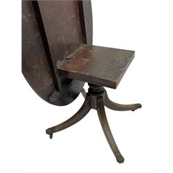 George III mahogany breakfast table, the oval top with a kingwood band and boxwood stringing, raised on a turned vasiform pedestal terminating in a fluted sabre tripod base with hairy paw feet and castors