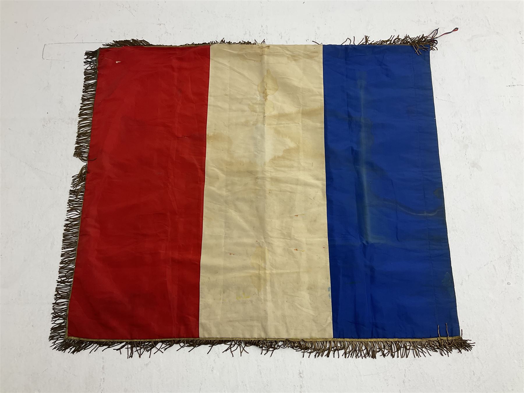 French State Police banner as the tricolor flag embroidered with coloured and metallic thread 'Societe De Secours Mutuels Un Pour Tous Tous Pour Un De La Police D'Eteat De Marseille' to one side; plain flag verso; tassels to three sides 100 x 113cm