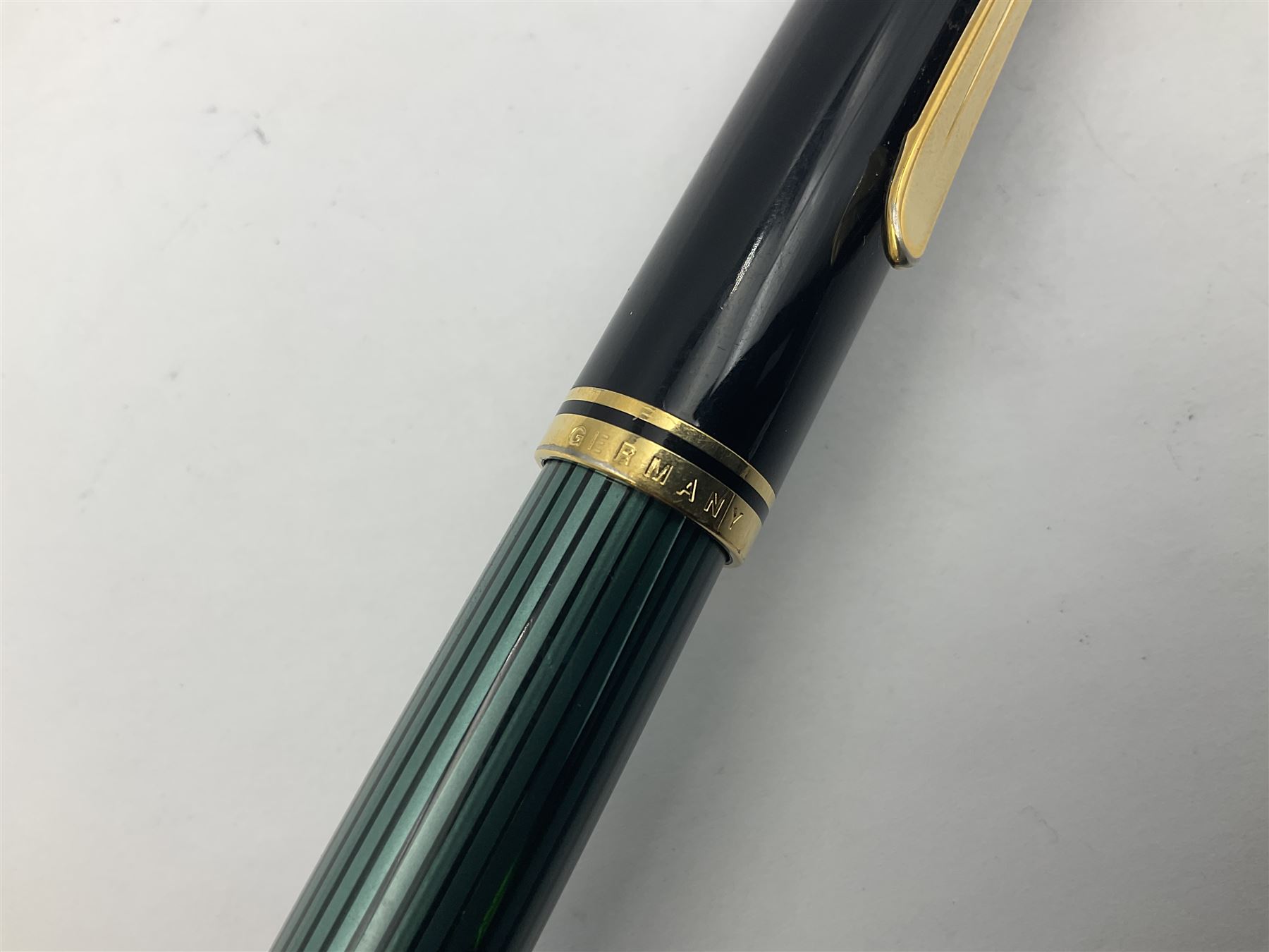Pelikan M800 Souveran fountain pen, the green and black striped barrel with gilt beak shaped clip and double cap band with gold bi-colour nib stamped 18C-750, L13.5cm
