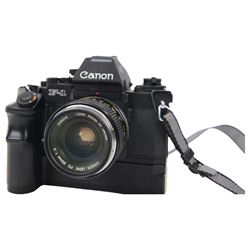 Canon F1 camera body, serial no. 223511, with 'Canon FD 35mm 1:2 FD' lens, serial no.23164, shoulder strap and Canon AE Power winder, serial no.174705