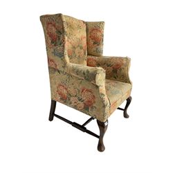 Early 20th century Georgian style wingback armchair, upholstered in floral fabric with sprung seat, walnut frame with front cabriole supports