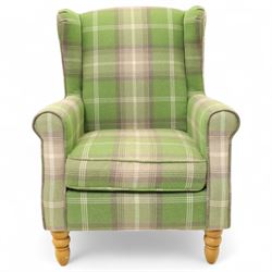 Contemporary green tartan upholstered wingback armchair, with scroll arms and loose seat cushion, raised on turned beech front supports with brass castors