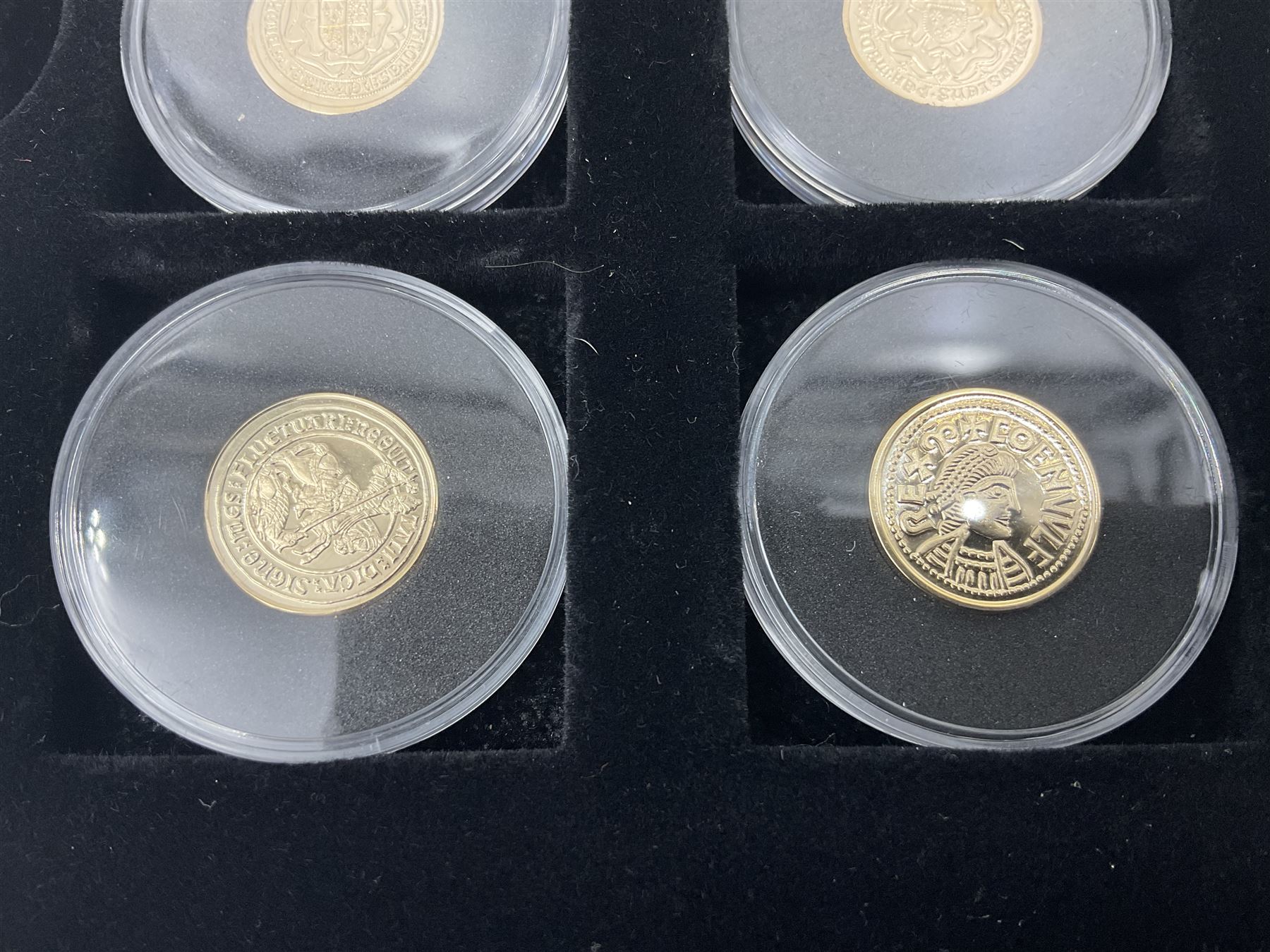 Sixteen hallmarked 9ct gold replica coins from 'The Historic Coins Of Great Britain Museum Gold Collection', housed in a Westminster display case, overall weight approximately 51.3 grams