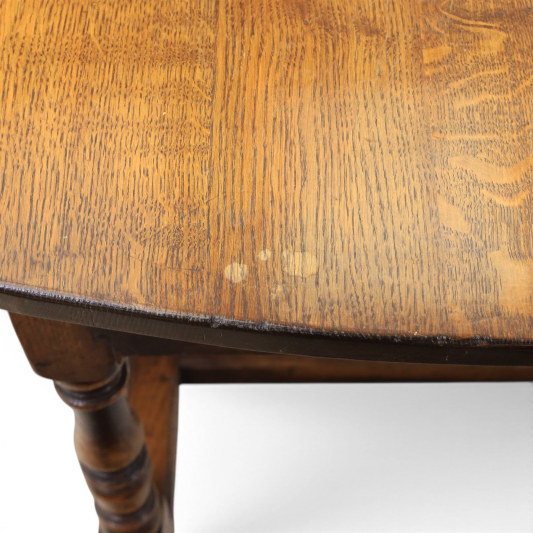 Titchmarsh & Goodwin - 18th century design oak oval drop-leaf dining table with leather dining chairs, the table with drop leaves forming an oval top extending to 180cm, with drawer to either side, raised on turned supports with gateleg, the chairs comprising two carvers in tan leather and two side chairs in green and tan leather backs, brass studded trim with turned uprights and stretchers