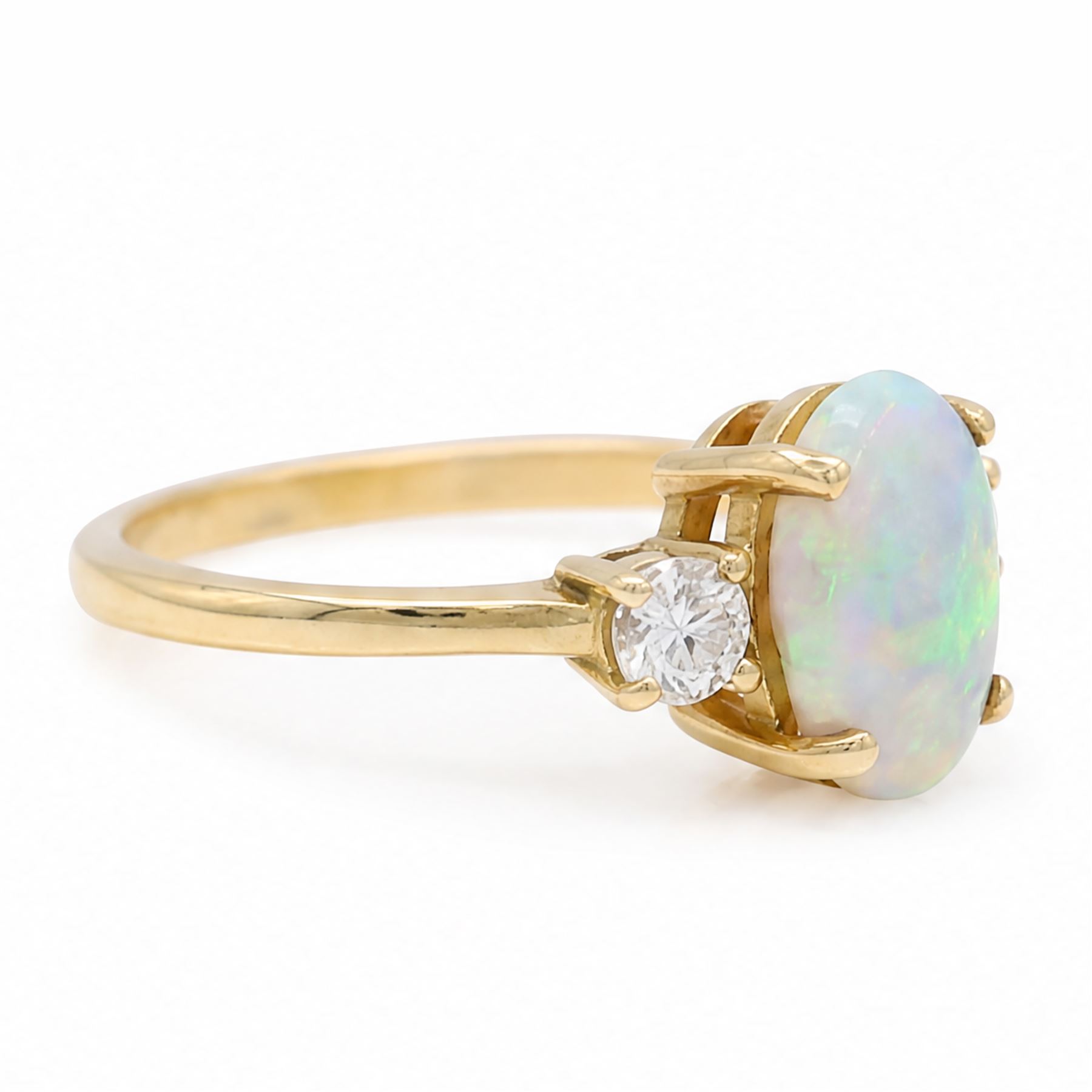 18ct god opal and diamond three stone ring, single oval cabochon cut opal of approx 2.80 carat, with a round brilliant cut diamond set either side, hallmarked, total diamond weight approx 0.25 carat