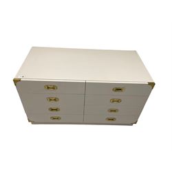 Military style painted drawer unit, fitted with eight drawers, applied brass handles and corner brackets, light grey and wax finish 
