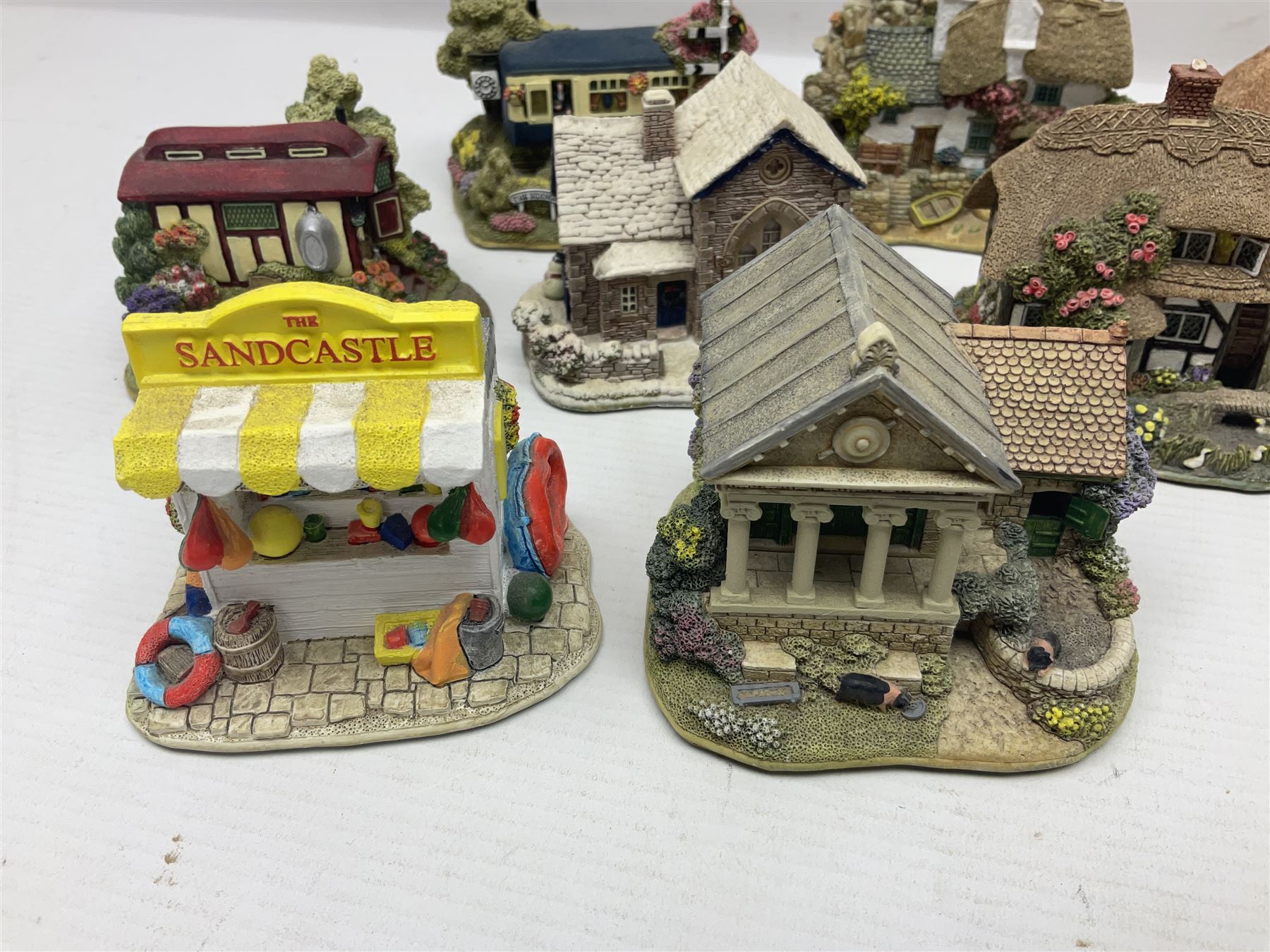 Eighteen Lilliput Lanes, including The Penny Farthing, The Pigsty, Borrowdale School, Fairy Cake Tearoom, An Apple a Day,Ladybird Cottage etc, all with original boxes 