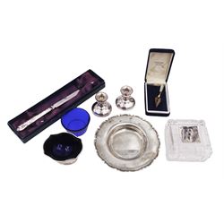 Group of silver, comprising ashtray, pair of miniature candlesticks, silver handled letter opener, glass box with silver plaque, etc, all hallmarked 