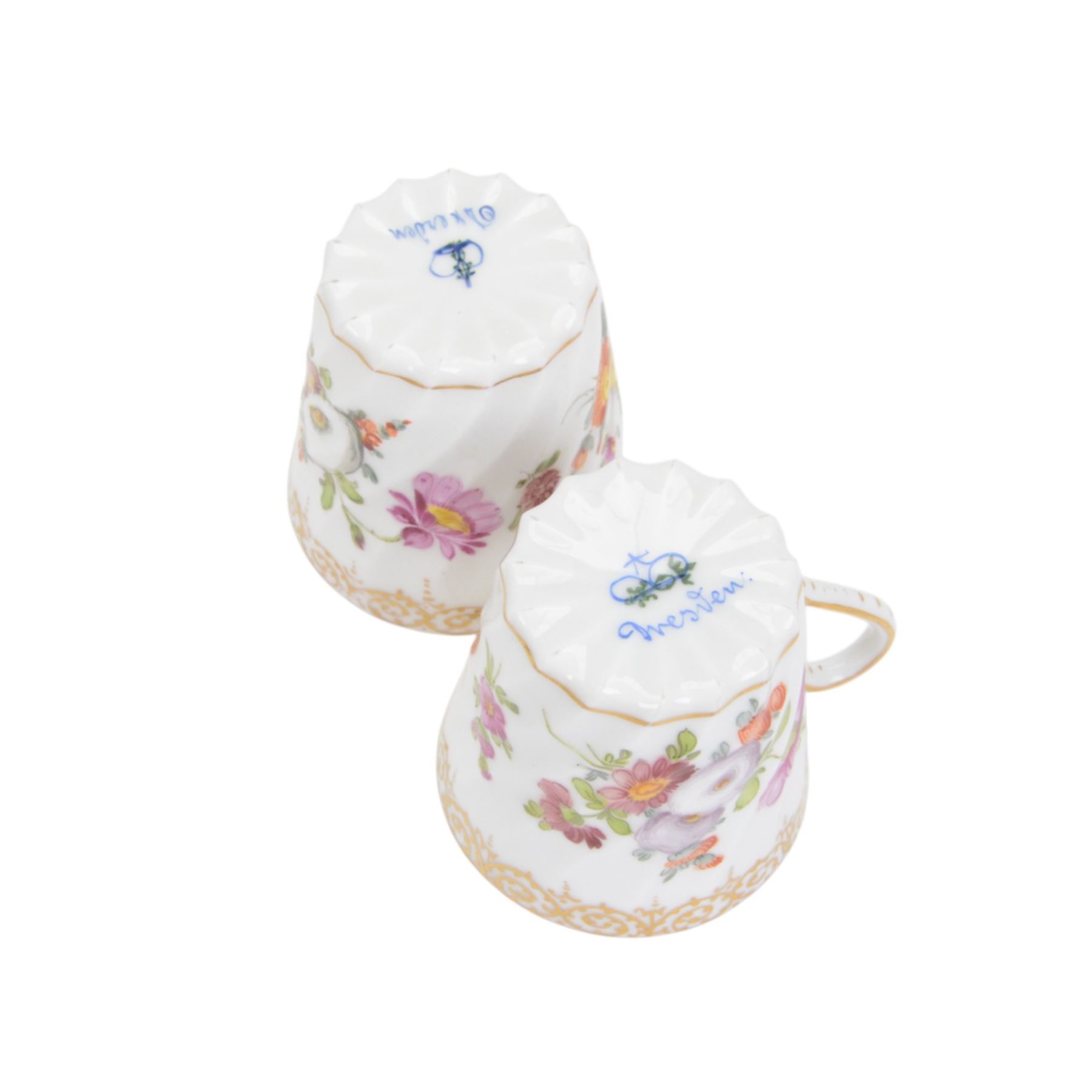 Two Dresden coffee cups and saucers, of fluted form decorated with flora spays together with two matching saucers and two dessert plates, cups H6cm  