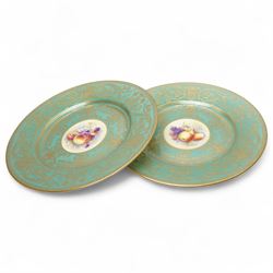 Pair of Royal Worcester cabinet plates painted with central panel of fruit by Peter Platt signed 'P Platt' within a green and gilt surround D27cm