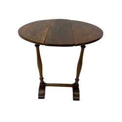 Small early 20th century Georgian style oak table, oval drop leaf top, twin turned pillar supports on stepped sledge feet, joined by stretcher