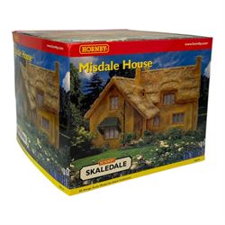 Ten Hornby '00' gauge Skaledale buildings, comprising R8505 The Kings Head Hotel, R8518 Old Green Cottages, R9716 City Dry Cleaners, R9678 Emma Williams Ladies Outfitters, R9800 Bus Shelter, R8637 Double Engine Shed, R8519 Misdale House, R8709 Fuel Oil Tanks, R8630 Toilet Block and R8603 Coal Staithes, all boxed