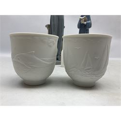 Two Lladro figures, comprising Conductor no 5196 and Prayerful Moment no 5500 together with a Lladro plaque and two Lladro candle holders, Dolphins at Play no 17666 and Sailing the Seas no 17665, all with original boxes, largest example H33cm 