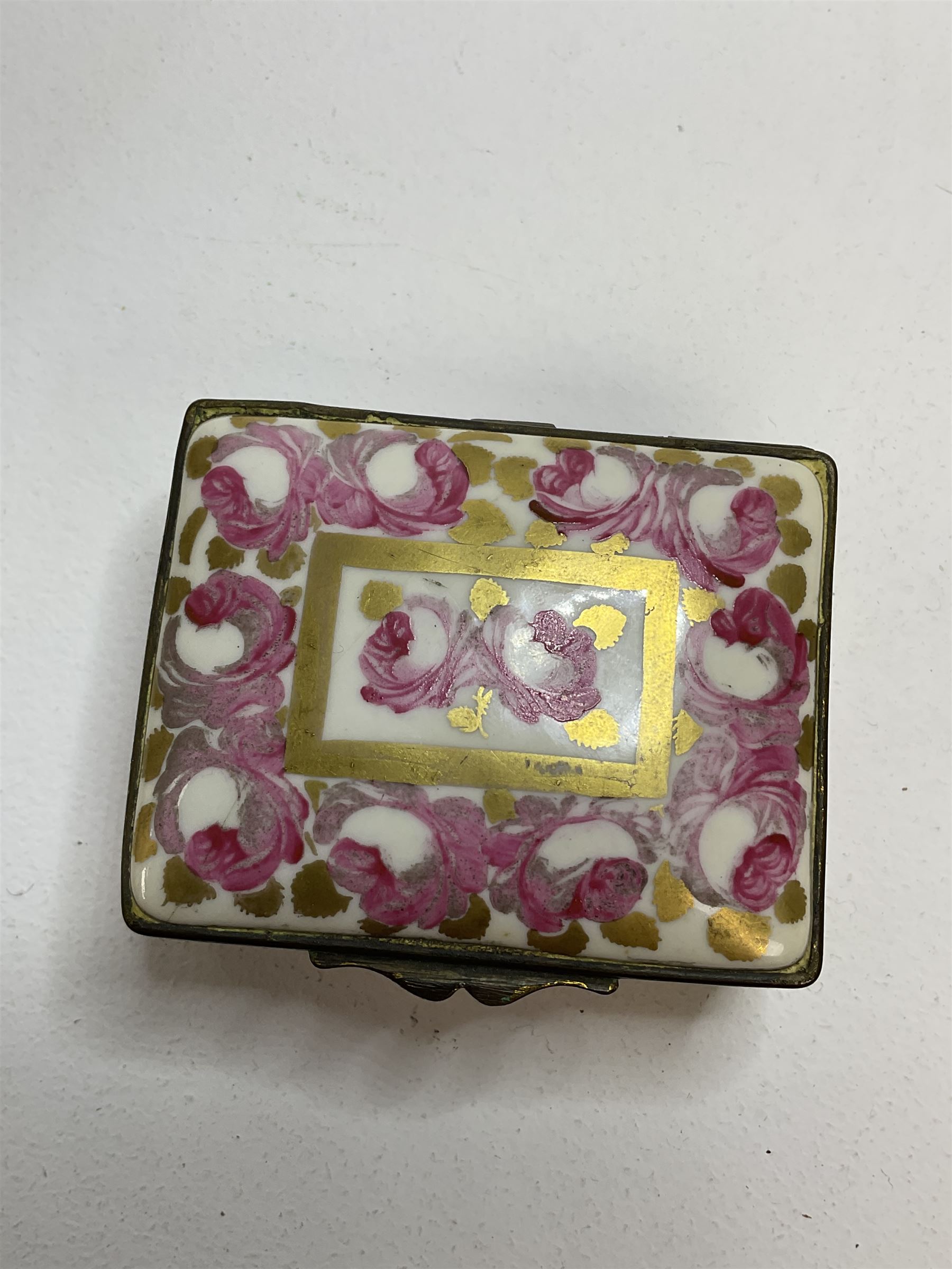 Early 19th century Swansea box of rectangular form, densely decorated with painted pink cabbage roses and gilt foliage upon plain ground, the hinged lid opening to reveal interior painted with two further roses upon plain ground, marked Swansea. in gilded lettering beneath, W7cm H3.5cm D5.5cm