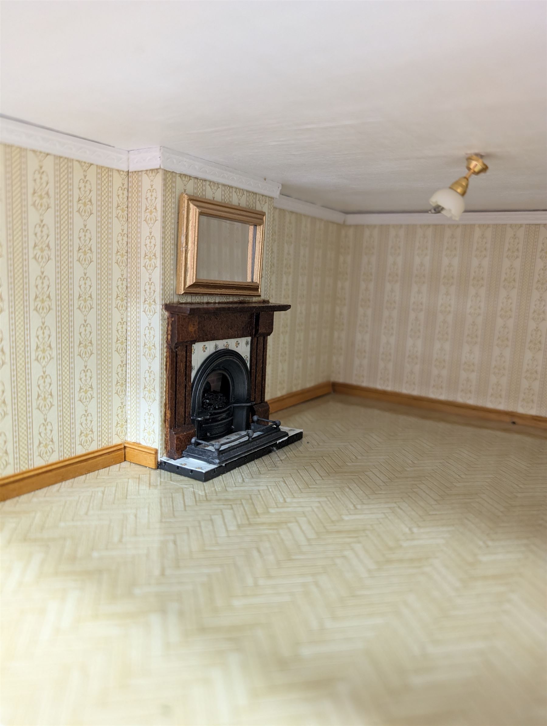 1:24 scale four-storey tudor-style dolls house, with black and white exterior, balcony garden, glazed panelled windows and wooden shingle roof, with decorated interior and wired fireplaces and lighting, H65cm, W58cm, D31cm, 