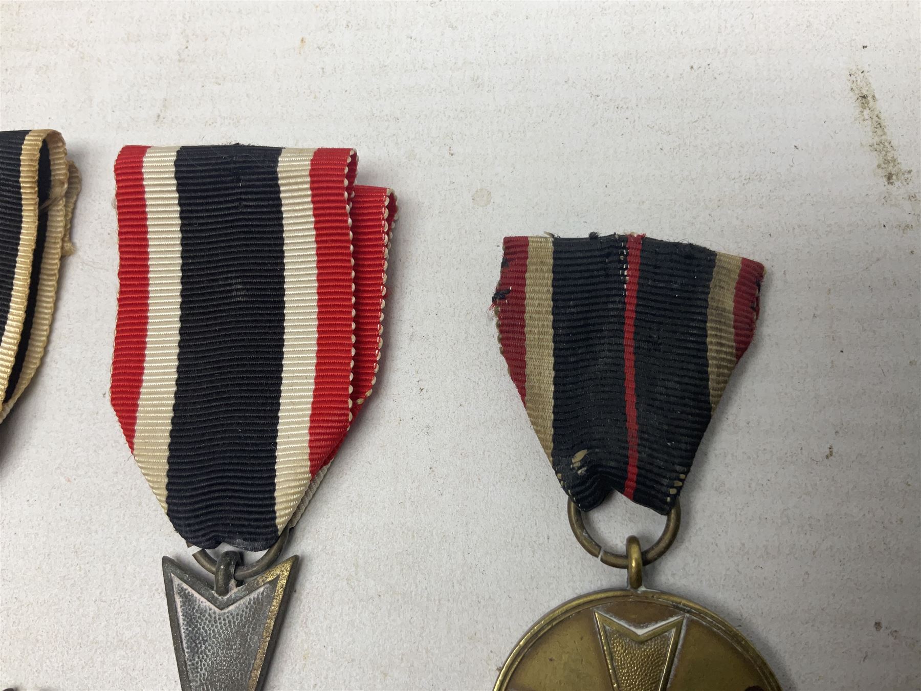 Two WW1 German medals - copy Cross of Honour with swords (combatants); Cross of Honour without swords (non-combatants); and two WW2 German medals - War Merit Medal; and War Merit Cross; all with ribbons (4)