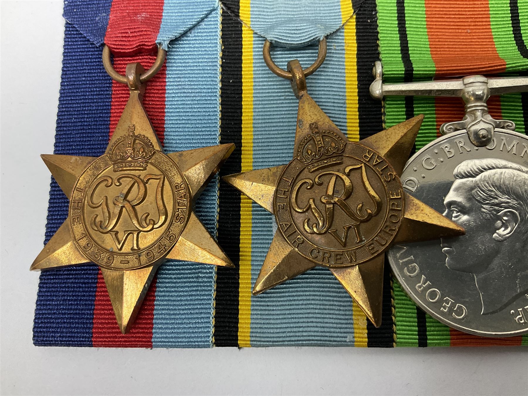 Group of five medals comprising 1939-1945 War Medal, Defence Medal, 1939-1945 Star, Air Crew Europe Star and Canadian Volunteer Service Medal with maple leaf clasp; all with ribbons and mounted on a display board