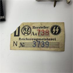 Three Reichsfuhrer 'SS' cuff titles; RZM 'SS' paper tag; German Water Police belt buckle; Destroyers badge marked RKS verso; N.S.B.O. lapel badge; and incomplete party eagle cap badge (8)