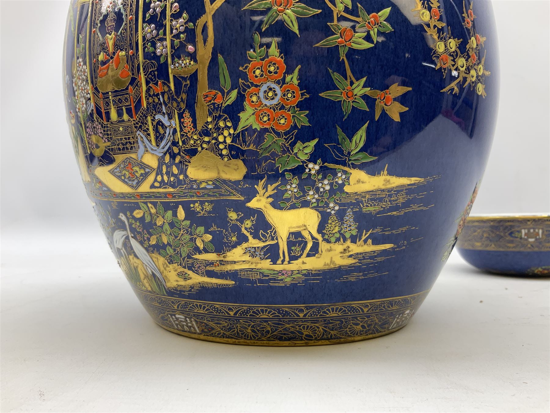 Carlton Ware Persian pattern ginger jar and cover decorated with an enamel and gilt Chinoiserie landscape with figures beside a pagoda upon a blue ground, with printed mark beneath, H27cm