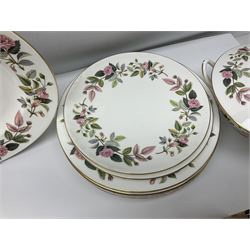 Wedgwood Hathaway Rose pattern tea and dinner wares, comprising twelve saucers, sixteen teacups, twenty tea plates, jug, sucrier, thirteen shallow bowls, sauce boat and saucer, two lidded tureens, larger jug, ten dinner plates, nine smaller plates and two large oval serving dishes