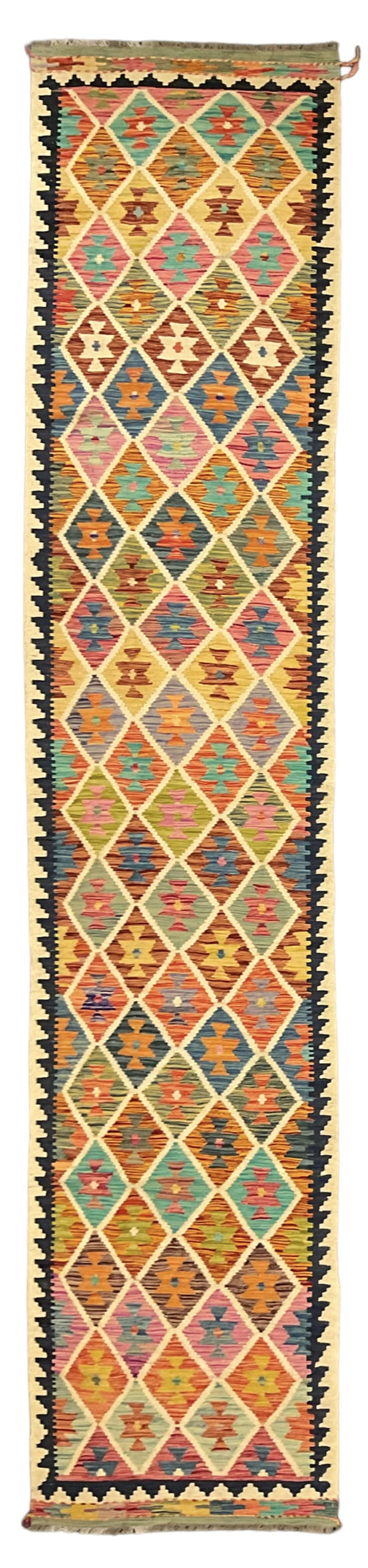 Anatolian Turkish Kilim ivory ground runner rug, decorated with all over multi-colour geometric lozenges with ivory outline