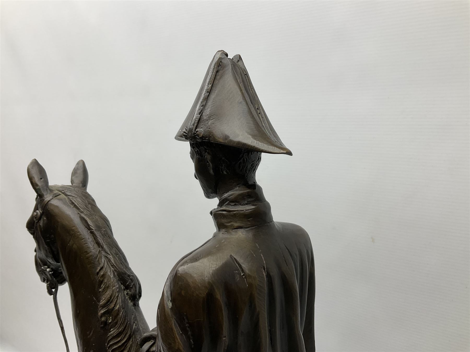 Large and impressive bronze figure of Wellington seated on a horse, on a sarcophogus shaped stepped base impressed 'Meunier Paris', the canted corners inset with battle trophies H68cm L50cm D22cm