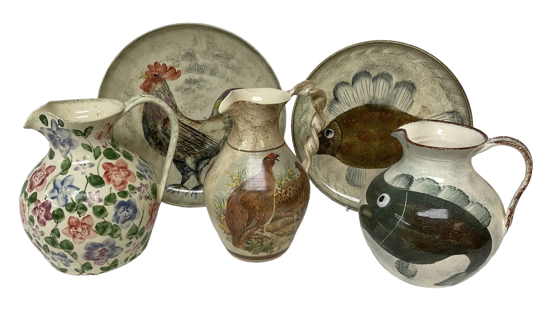 Collection of Yorkshire Moorlands Pottery, comprising two large circular dishes and three jugs, decorated with various fish, flowers, red grouse and cockerel