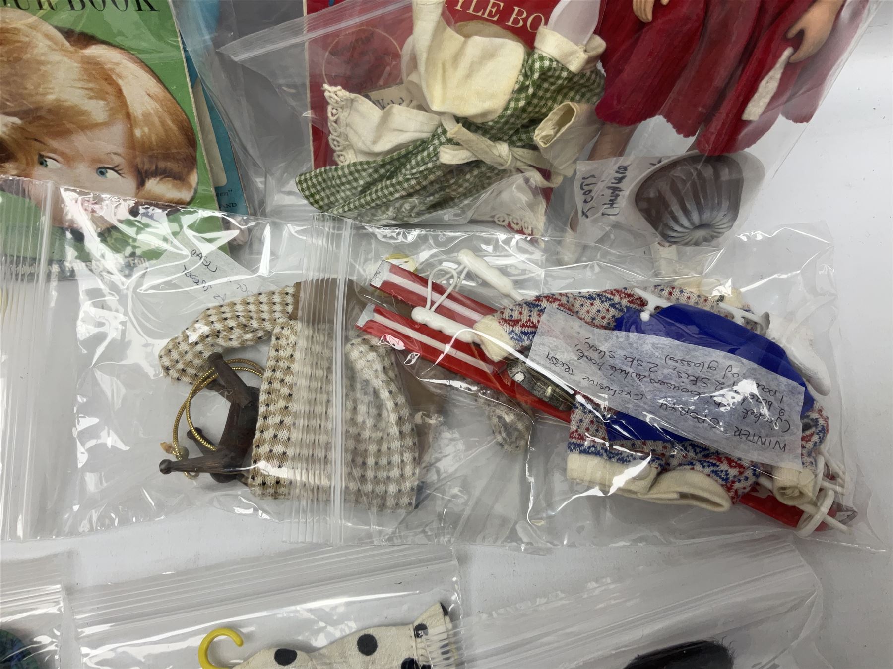 1960s Palitoy Tressy fashion doll, boxed with stand and booklets; four additional Tressy outfits (In The Office, Winter Journey, Winter Sports and Evening Date); two other outfits; and Tressy's Little Sister Toots doll with Style Book and additional outfit