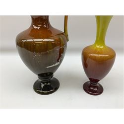 Linthorpe pottery vase with crimped rim and ovoid body, Linthorpe jug with high loop handle and crimped spout, a pair of candlesticks with a green, brown glaze and other similar pottery 