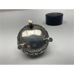 Three pin cushions, comprising gilt metal pig, silver plate shoe, circular pin cushion on threel feet, together with black pin holder with silver writing to the lid 