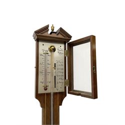 Comitti-20th century mercury stick barometer in an 18th century style mahogany case with satinwood stringing, with a broken pediment, brass finial and round base, silvered register with recording vernier, weather predictions and a centigrade/Fahrenheit spirit thermometer enclosed within a glazed door, visible tube with a bulb cistern and turned mahogany cover.
Mercury clean and present with no air locks.