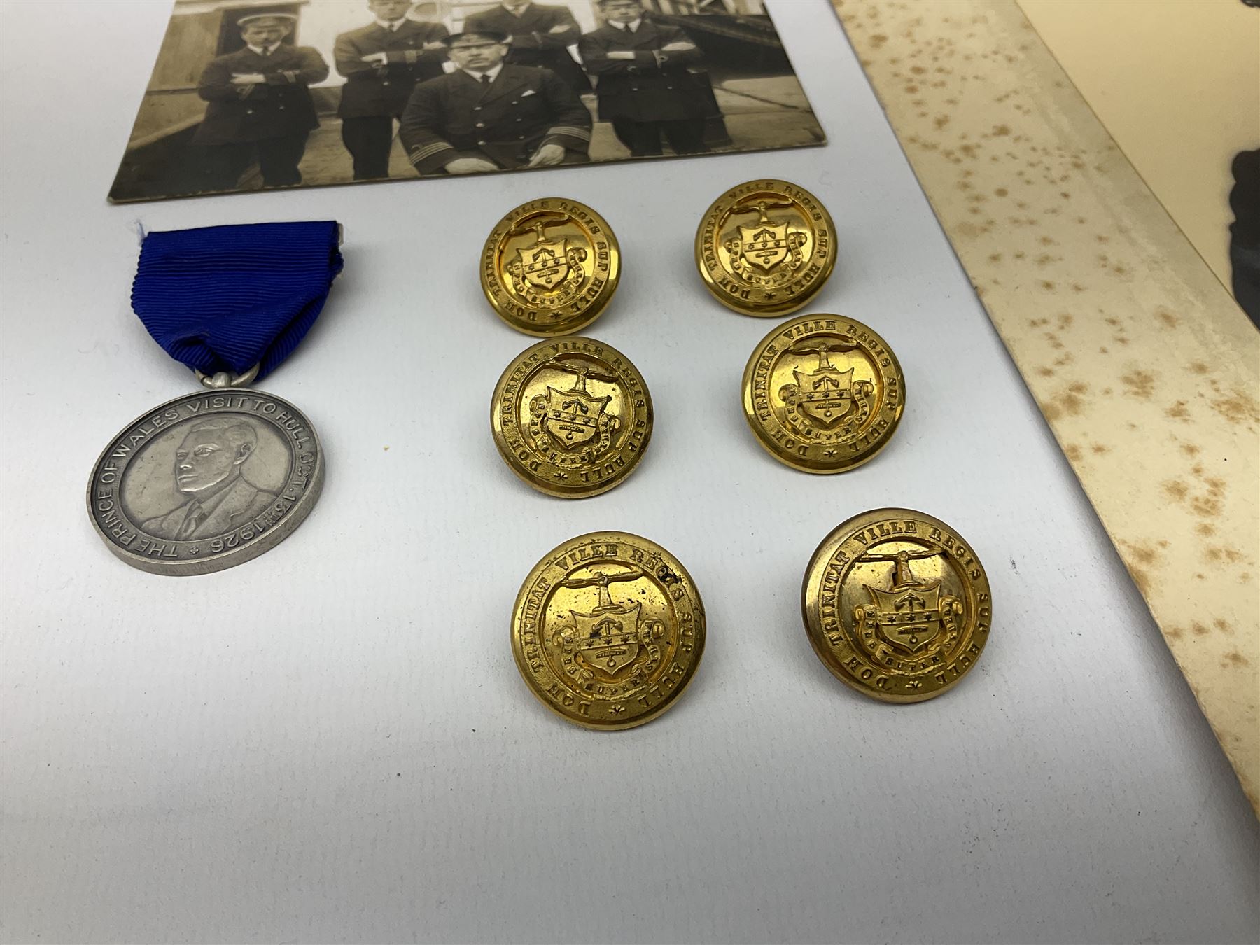 Trinity House Hull - hallmarked silver medal commemorating the visit of the Prince of Wales October 13th 1926; photograph of Captain J. Collins Warden 1934-35; photographic postcard of Capt. Collins onboard ship with other crew members; and six Trinity House uniform buttons