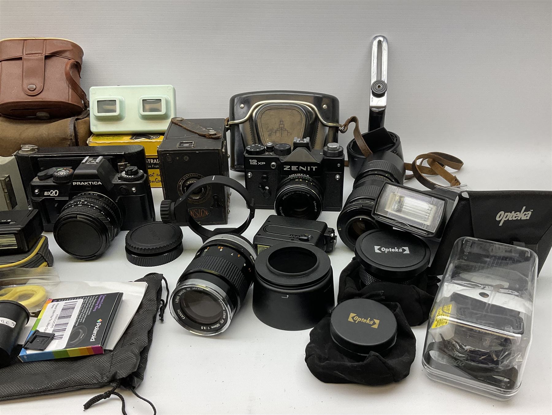 Vintage and later cameras, lenses, accessories and darkroom equipment including Zenit 12XP camera, Praktica BX20 camera fitted with 'Sigma Zoom Master 1:3.5-4.5 f=35-70mm' lens, Praktica LLC camera fitted with 'Carl Zeiss Jena Pancolar 1.8/50' lens, Canon Zoom Lens 'EF 100-300mm 1:5.6', various Jessop and other makers darkroom items including safelight (Red), universal duo tank, multi-mask enlarging easel etc, in three boxes