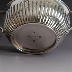 Victorian silver four piece tea service, comprising coffee pot, teapot, twin handled open sucrier and milk jug, all of oval part fluted form and engraved with initial to body, the coffee pot on oval stepped foot, coffee pot and teapot with ebonised wooden finials, hallmarked Elkington & Co, Birmingham 1888