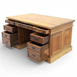 Late 19th century Victorian pine twin pedestal desk, rectangular plank top above an arrangement of seven drawers with brass swan neck handles, each pedestal fitted with one drawer above a double height drawer, raised on plinth bases with panelled sides