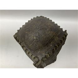 20th century Benin bronze head of an Oba, donning headdress and neck rings with wide open eyes, raised upon a tapering square base, the sides with relief cast knot decoration, H39cm