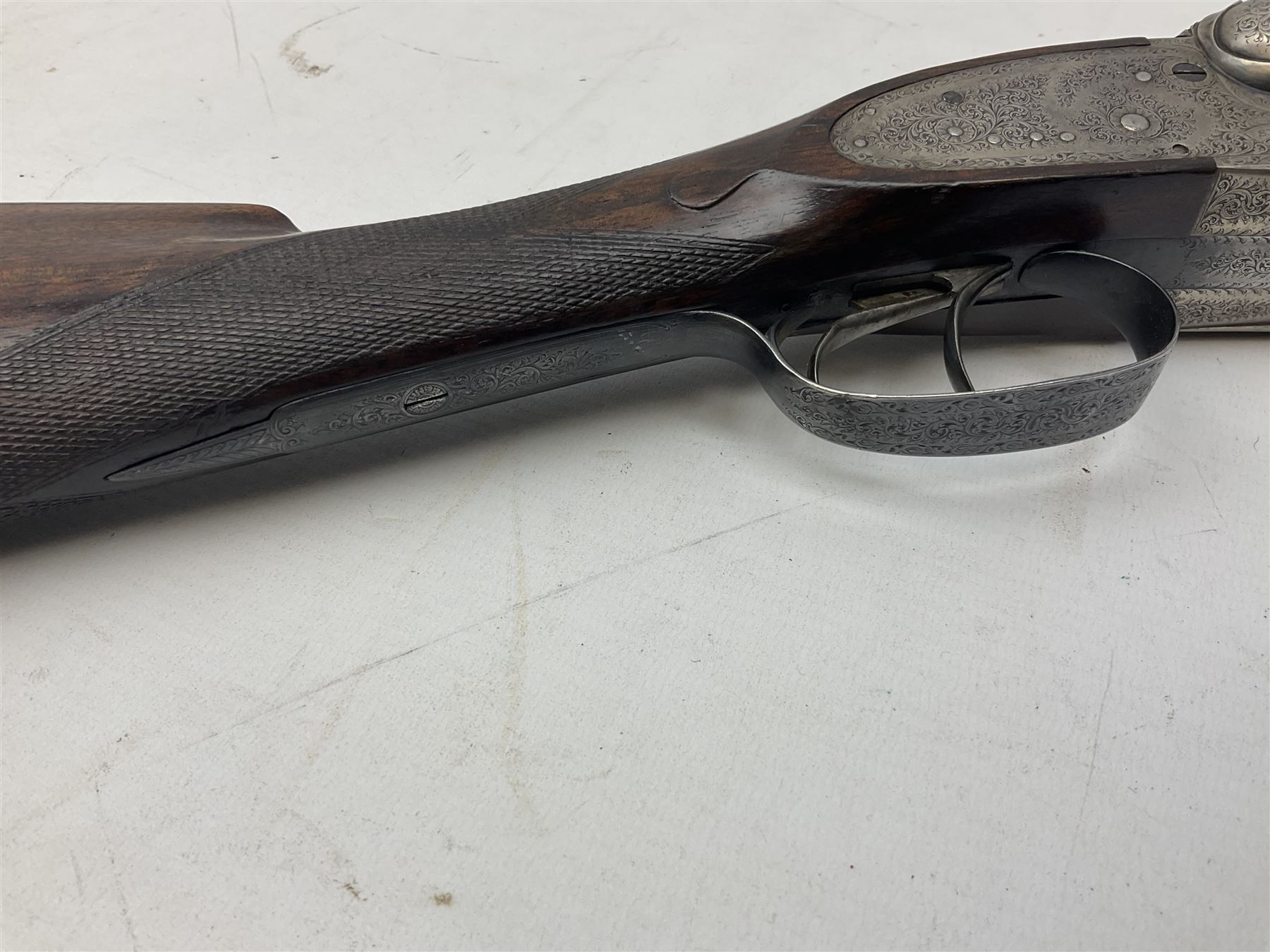 Smith Midgley Bradford 12-bore side-by-side double barrel side-lock ejector shotgun with 71cm barrels, engraved action with patented top lever, ivy leaf fences and top safety, walnut stock with chequered grip and fore-end, serial no.62409 to barrels and 1481 to action, L115cm overall SHOTGUN CERTIFICATE REQUIRED