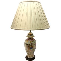 Table lamp of baluster form, decorated in the Oriental style with phoenix and dragon amidst blossoming flowers, with plated cream fabric shade, lamp base not including fixtures H35cm